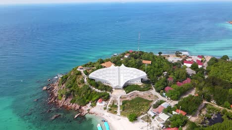 aerial 4k drone footage of a manta ray shaped building on the coastline of the seashore city of pattaya in eastern side of the gulf of thailand