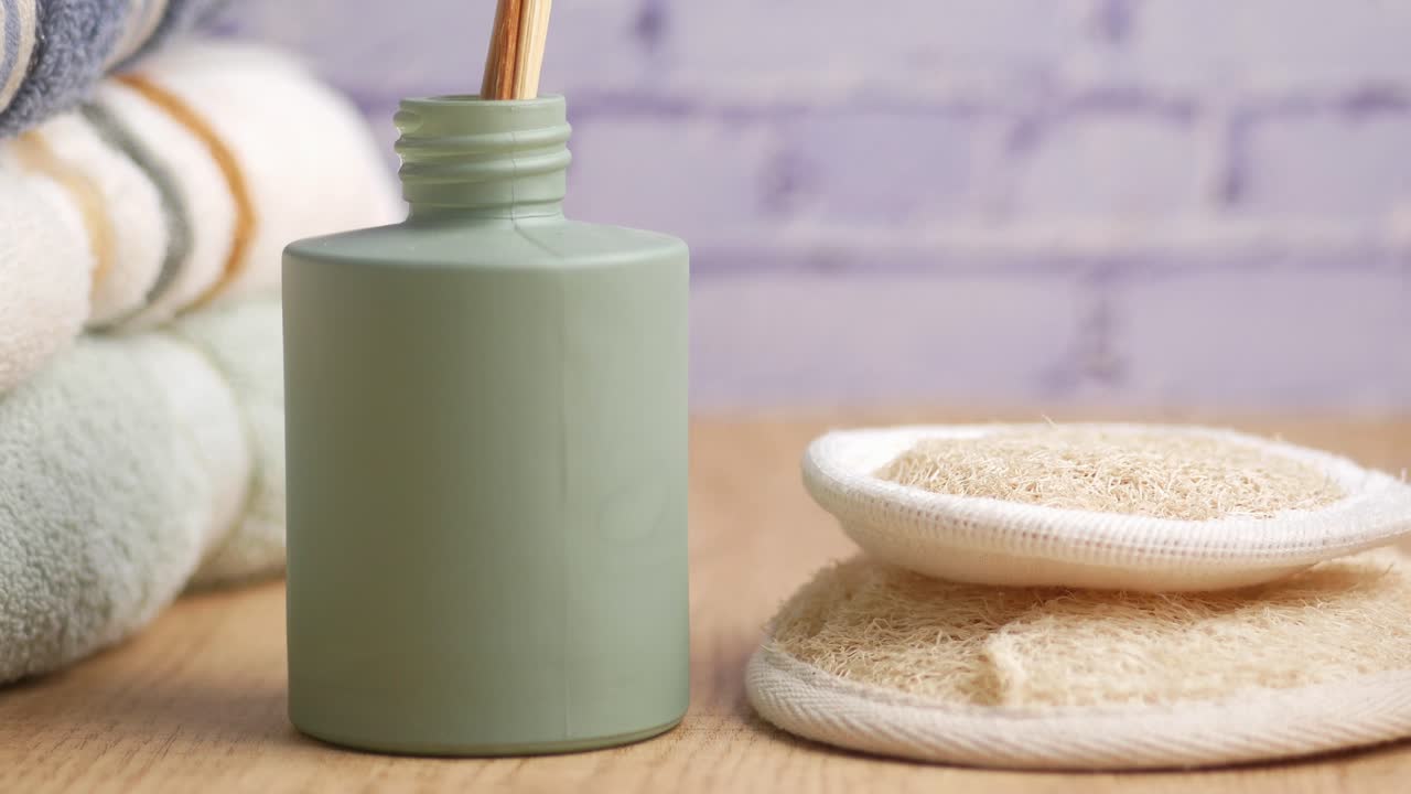 Spa still life with diffuser, loofah, and towels