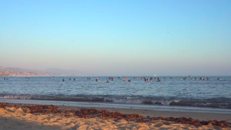 Surfers-and-people-enjoying-the-water-at-Laguna-Beach,-CA