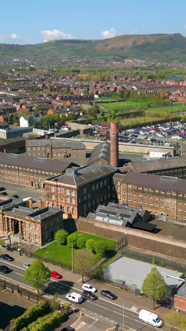 Tight reversing social ratio aerial video of Crumlin Road Gaol in Belfast, County Antrim, Northern Ireland, UK on a sunny day. Produced in 1080x1920 vertical ratio, 60FPS and with Rec709 color