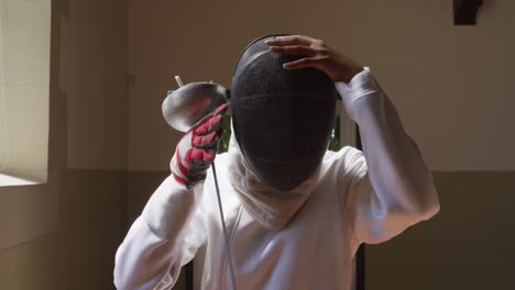 female fencer athlete during a fencing training in a gym