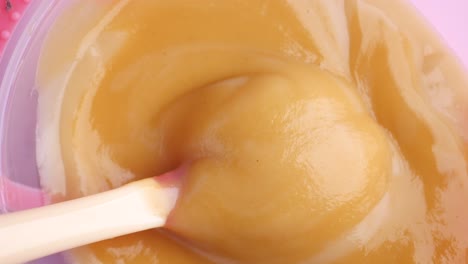 comida para bebés en un recipiente con cuchara