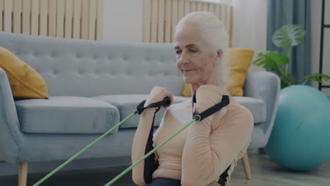 senior woman doing resistance band exercises at home