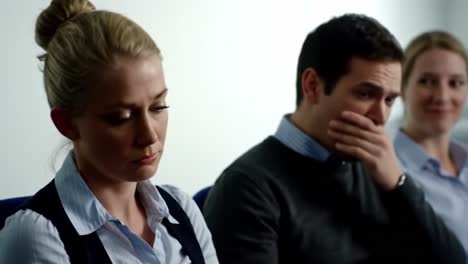 in a corporate meeting room, three colleagues showcase different emotional responses during a discussion.