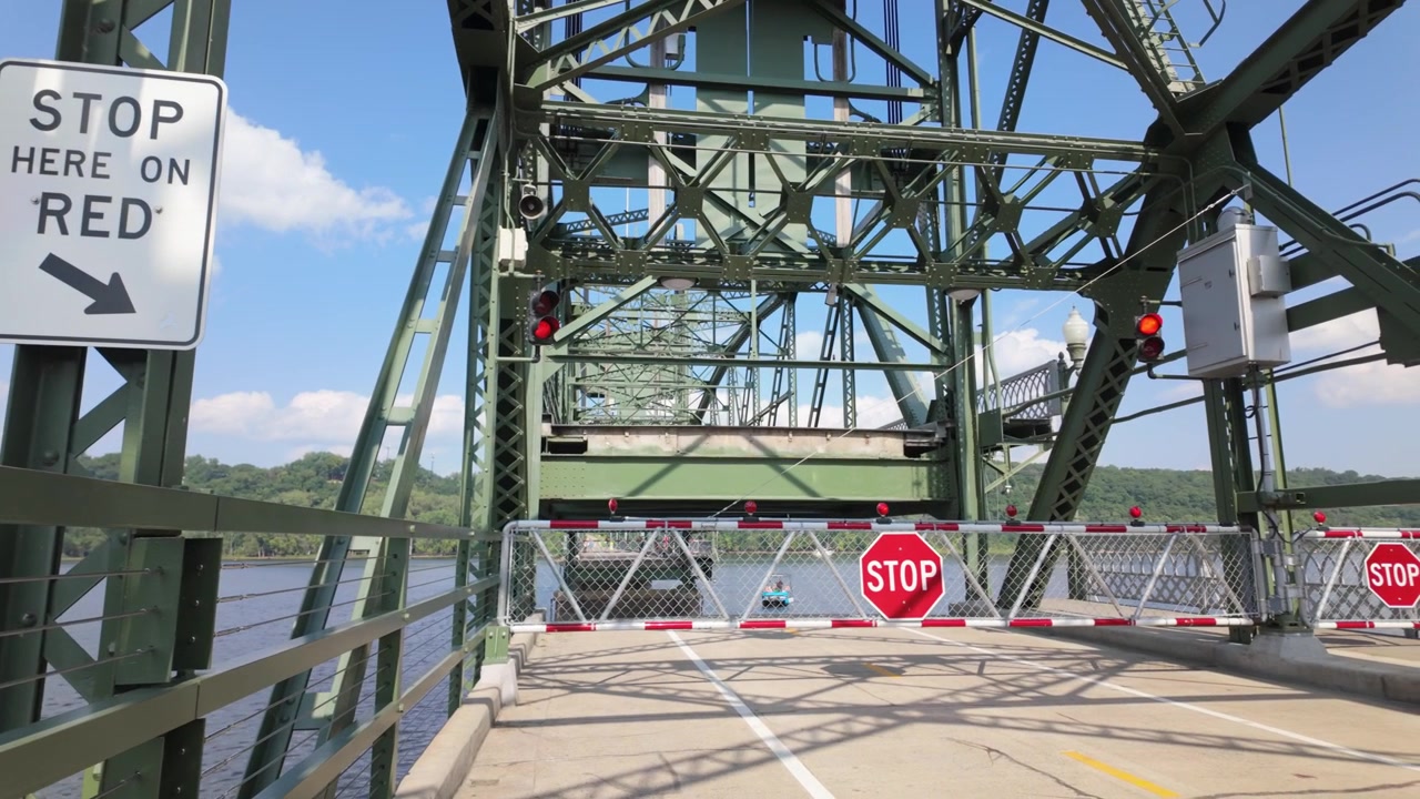 Gimbal wide shot of the lift bridge deck raising over the St. Croix River in Stillwater, Minnesota. 4K
