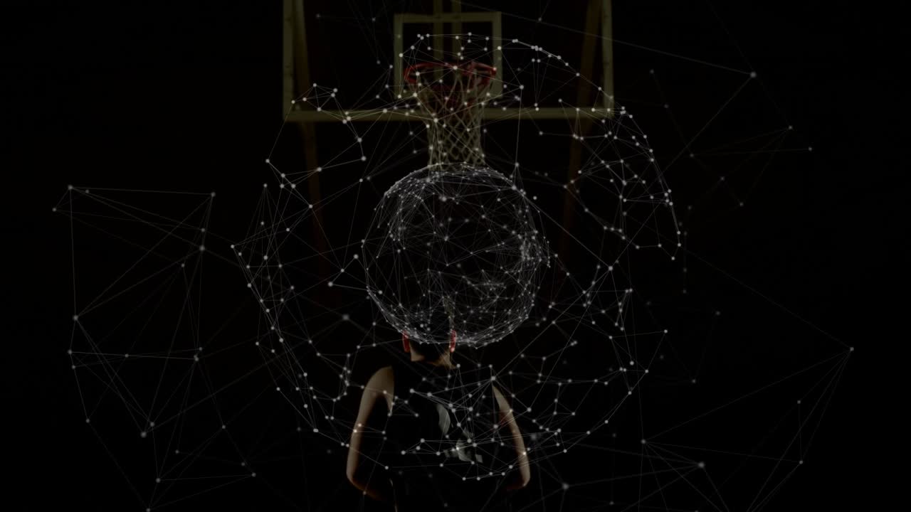 Male athlete holding basketball at hip starting sphere on torso below sports hoop prepping shot