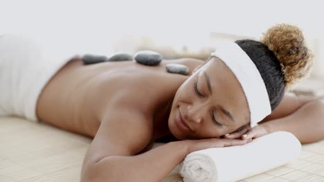 Woman-Getting-Hot-Stones-Massage-At-Spa