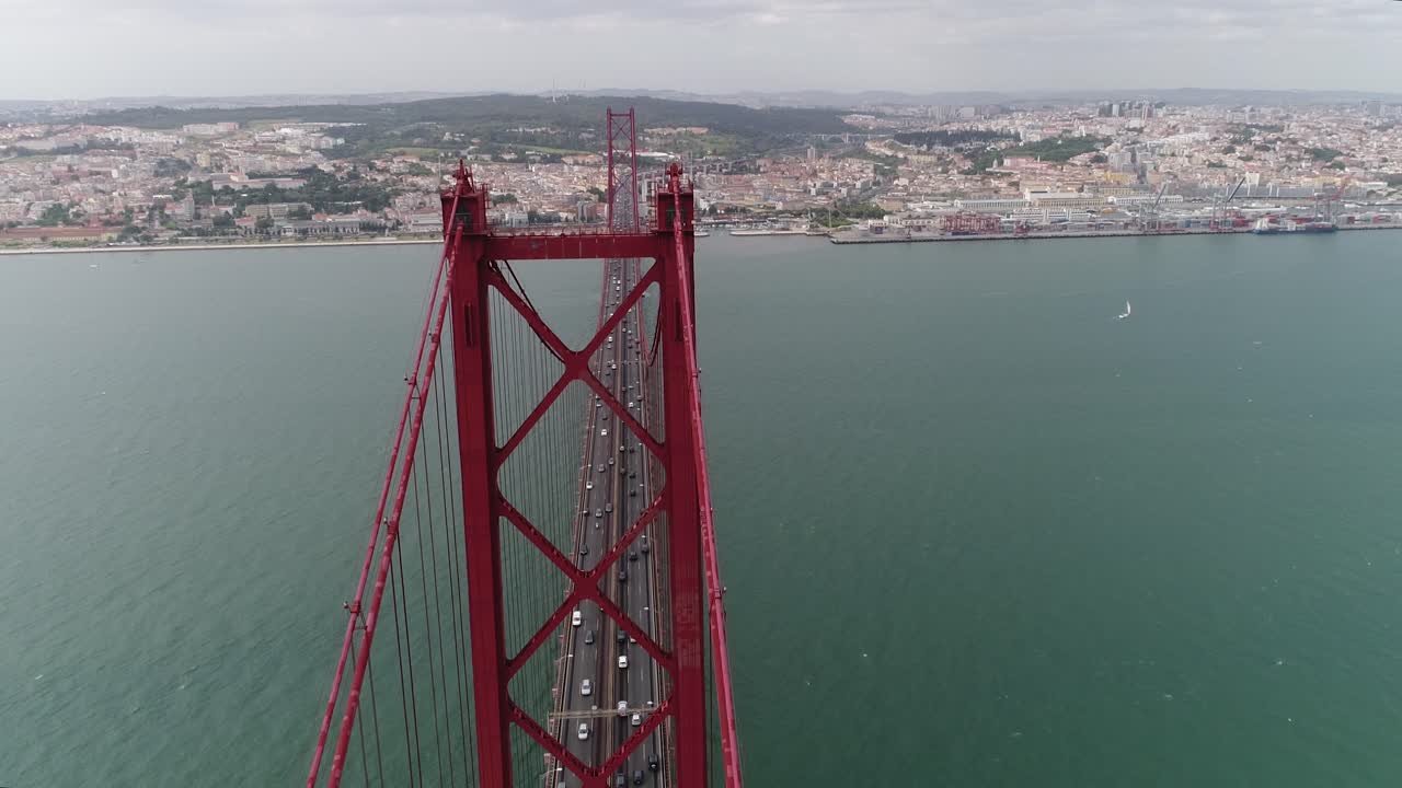 Vista aerea del Ponte 25 de Abril sul fiume Tago a Lisbona, Portogallo, in una giornata soleggiata con nuvole soffici.