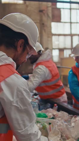 recycling facility workers sorting waste
