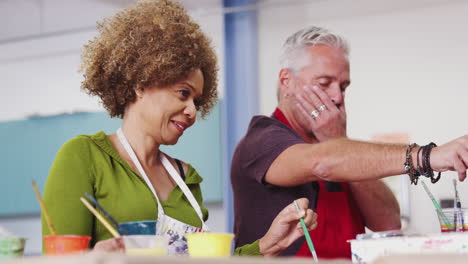 Two-Mature-Students-Attending-Art-Class-In-Community-Centre