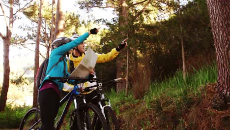 mountain biking couple looking at map