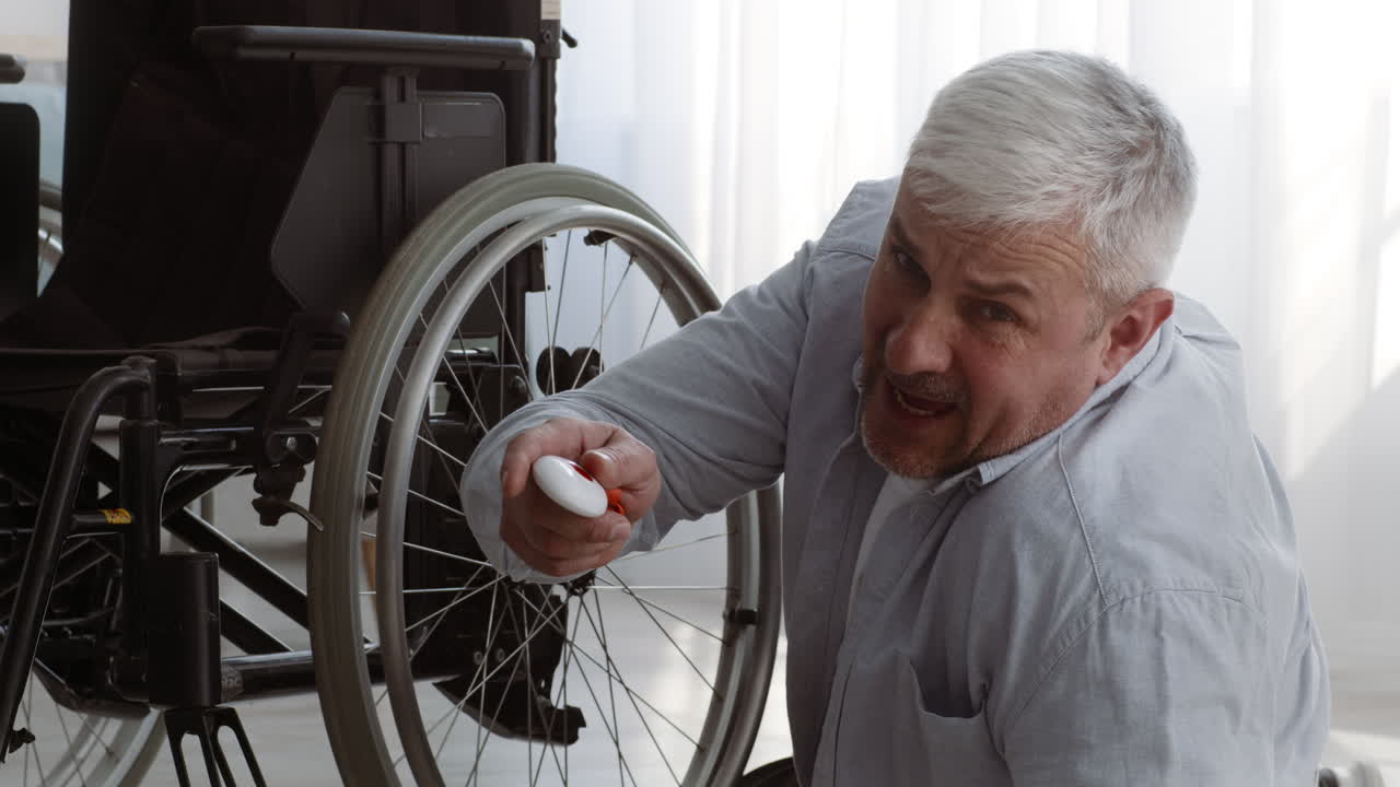 Elderly Man Using a Wheelchair Remote Control