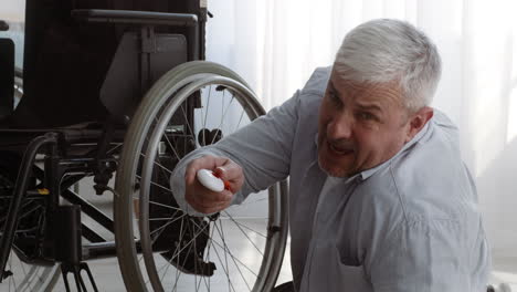 elderly man using a wheelchair remote control