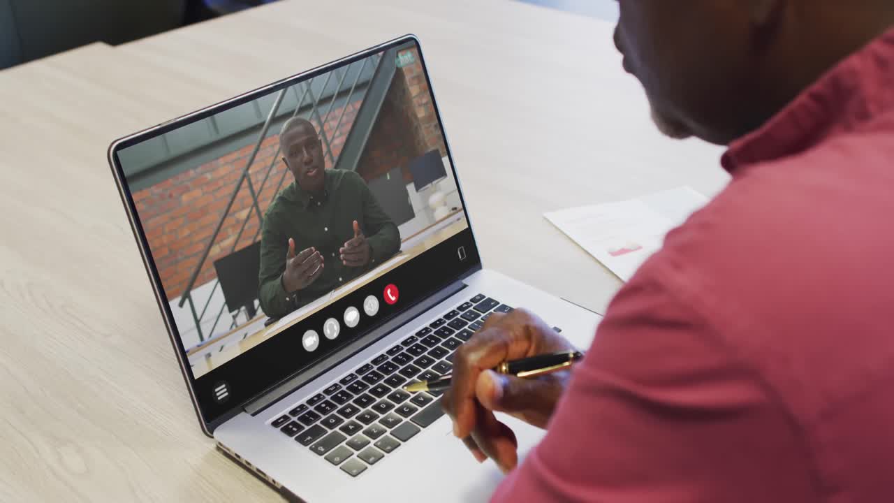 African american man using laptop for video call, with business colleague on screen