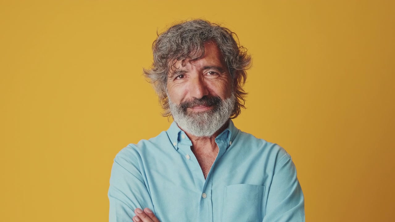 Mature Man With Gray Beard Winking at Camera