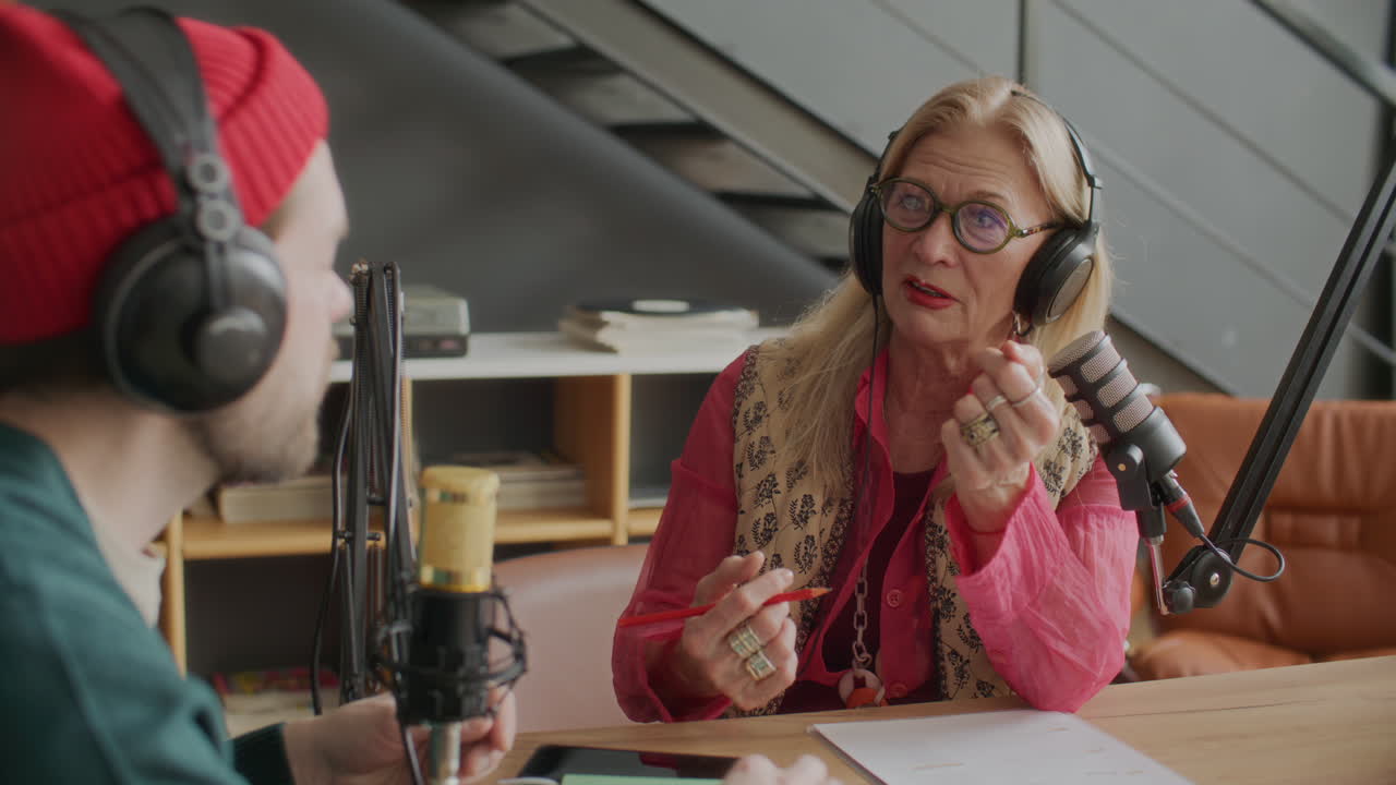 Senior Female Blogger Recording Podcast with Co-Host in Studio