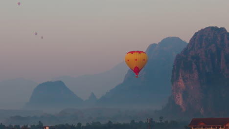 hot air balloon sunrise over mountains