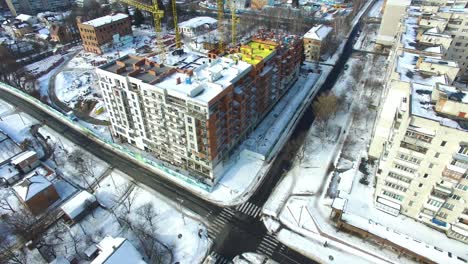 newly constructed building. crane and building construction site in winter