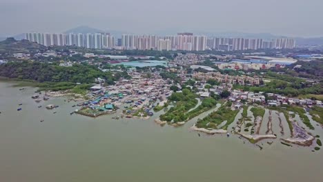 a dynamic descending aerial footage of the fishing village in lau fau shan in the new territories of hong kong