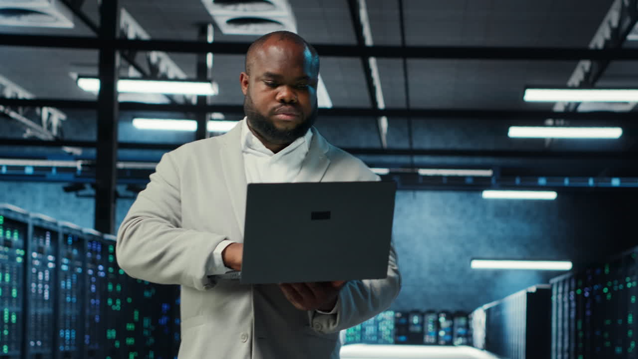 Vertical video Data center engineer analyzing equipment performance, resolving technical issues