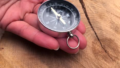 round compass in a female palm