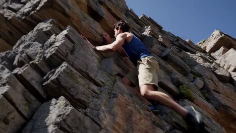 man rock climbing on a sunny day