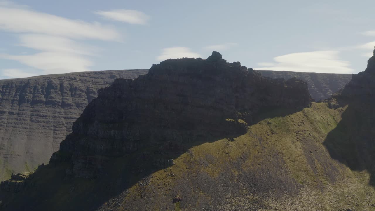Drone orbiting around the peak of Svalvogar mountain in Iceland in the Western Fjords