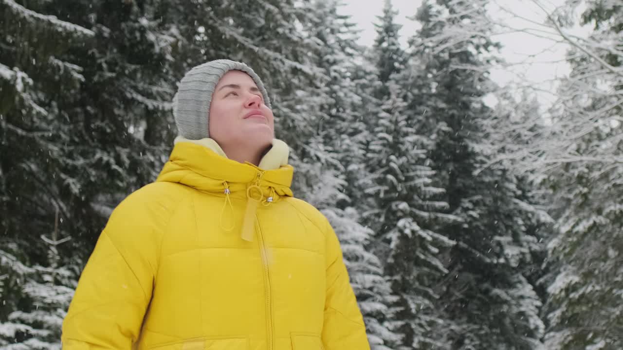 Woman in Yellow Jacket in Snowy Forest