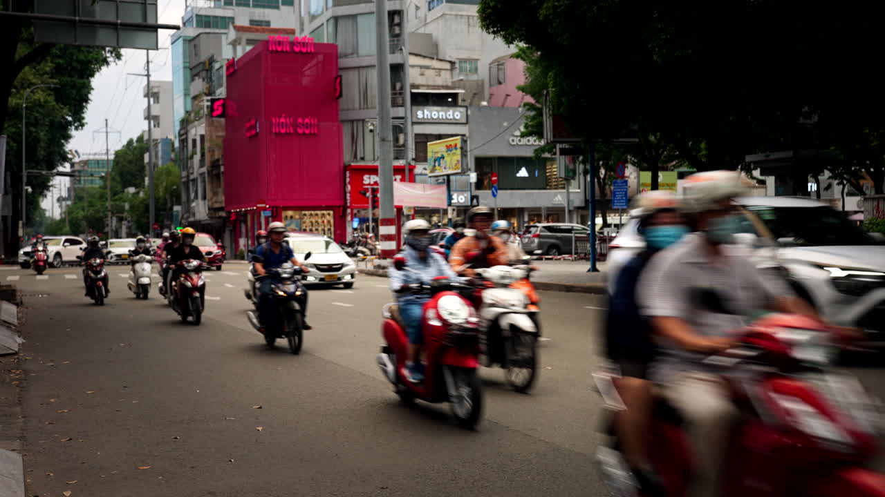 Busy City Street Scene in Vietnam with Motorcycles and Cars