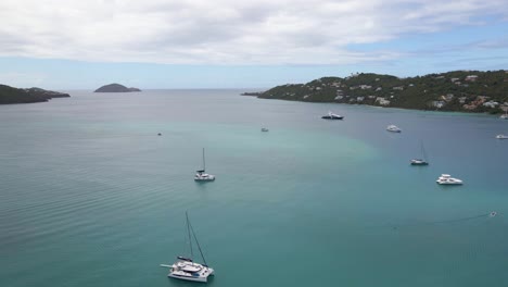 aerial view of boats on the coast of st thomas island, usa - ascending, drone shot