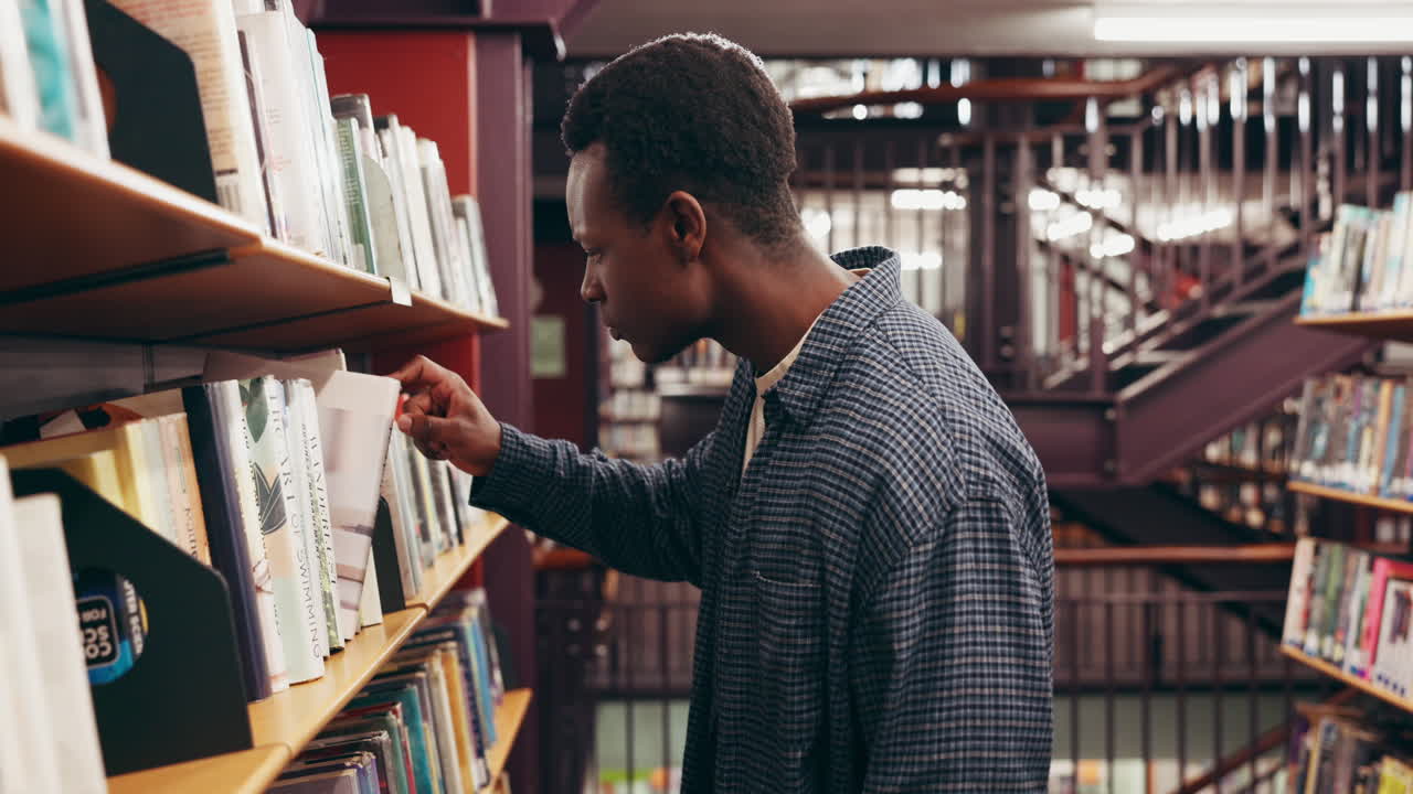 A man browsing books in a library