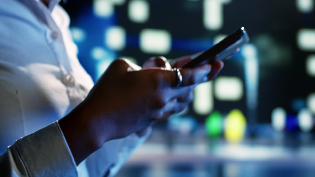 Woman uses smartphone at night, close up