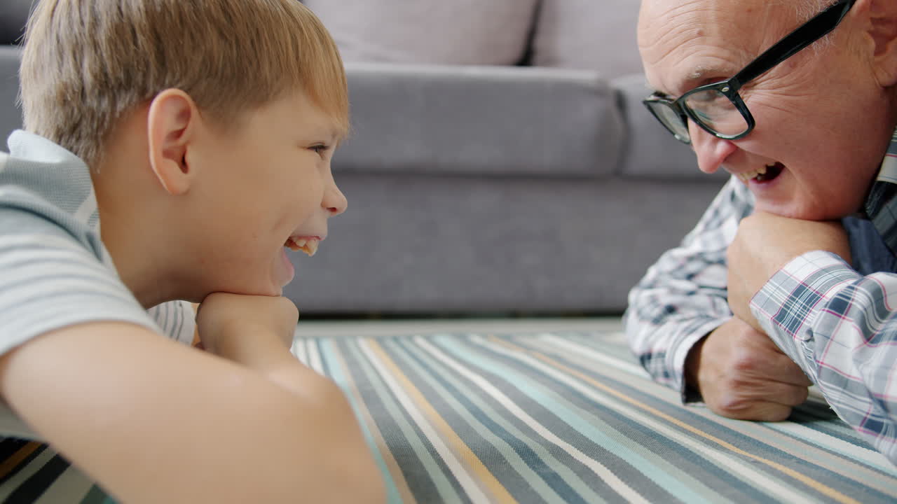 Grandfather and Grandson Playfully Interact on the Floor