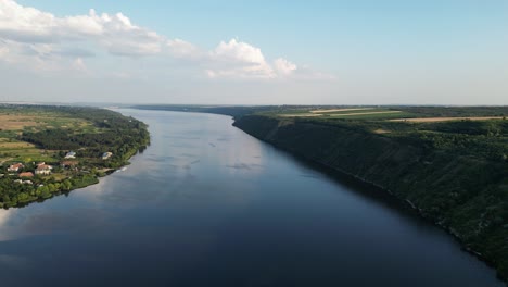 birds-eye view of dniester river timeless water, which flows through picturesque countryside of moldova and ukraine, peaceful evening