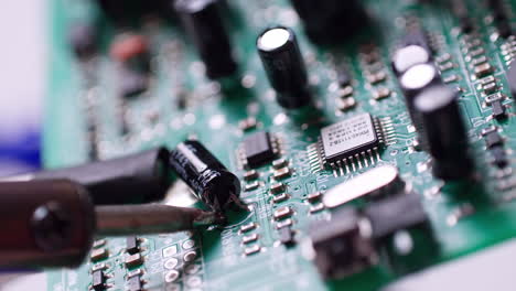 the engineer replaced the ic transistor with a soldering iron on the electrical circuit pcb board to fix device device