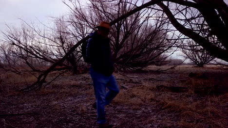 On-a-dark-and-gloomy-day,-a-man-walks-through-the-forest