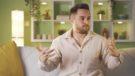 Young-man-is-overwhelmed-and-unhappy-at-home,-angry-with-himself.