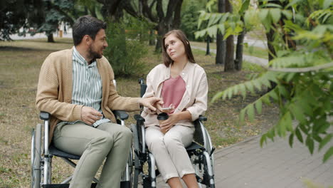 couple in wheelchairs enjoying time in park