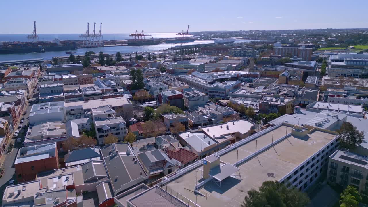 Drone view above buildings in Fremantle with cargo port in background, Perth, Australia