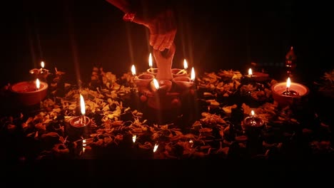 placing a mud lamp on a table decorated with mud lamps for a festival in the dark background