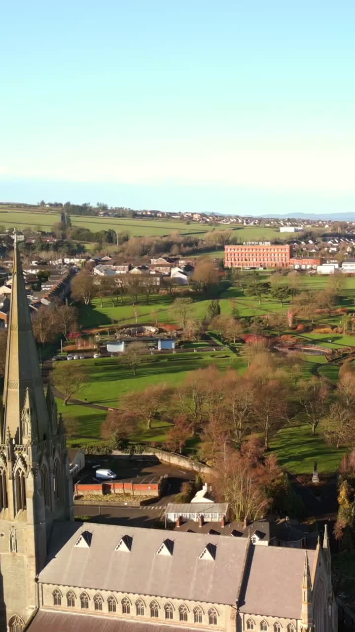 Slow reversing social media ratio aerial GV video of Derry City, County Londonderry in Northern Ireland. Filmed in 1080x1920, 60FPS and with Rec709 color