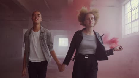 fashionable young man and woman in an abandoned warehouse