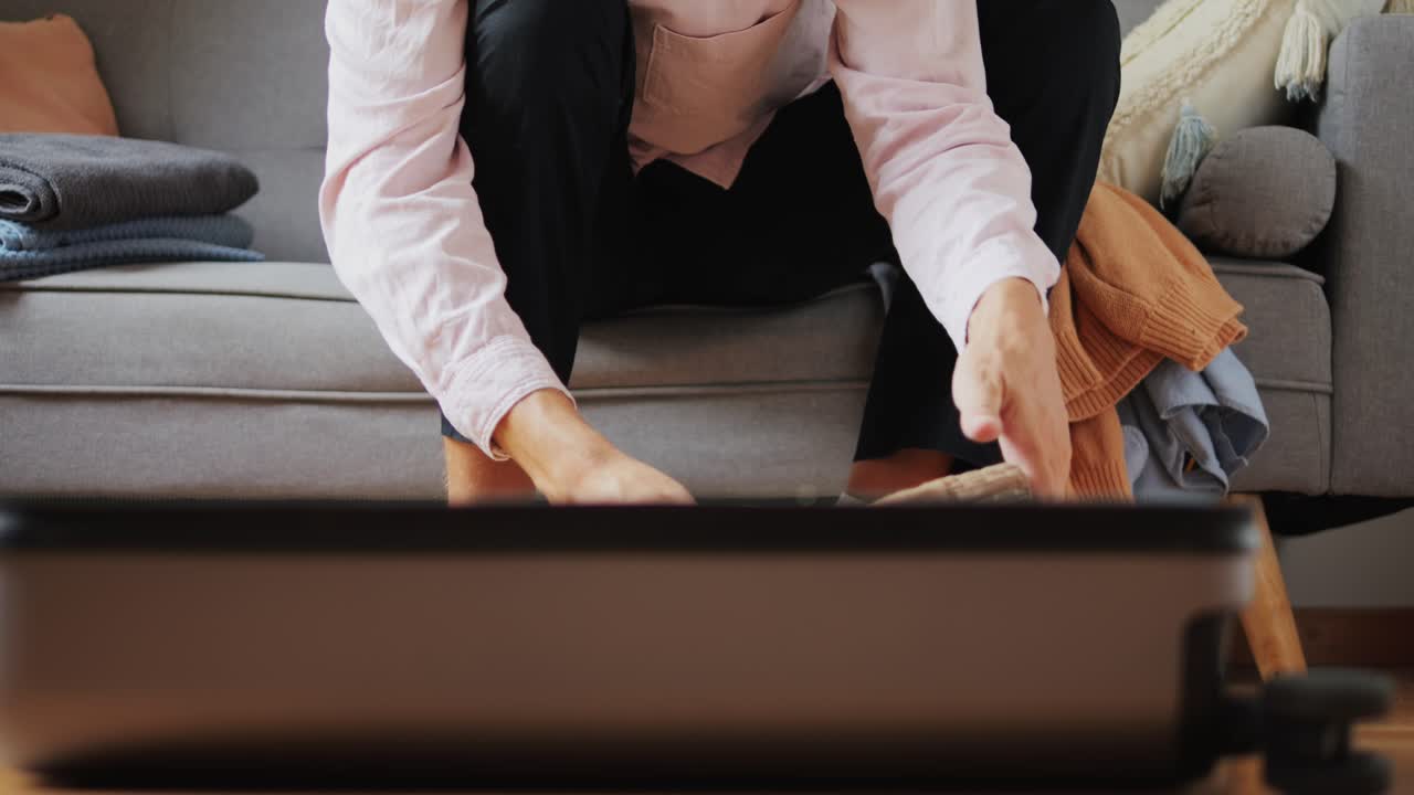 Tourism and travelling concept. Handsome business man going on holiday, packing his suitcase, checking luggage, sitting on bed and looking at packed things