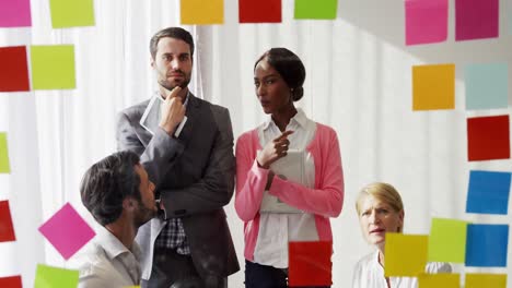 businesspeople interacting over sticky notes