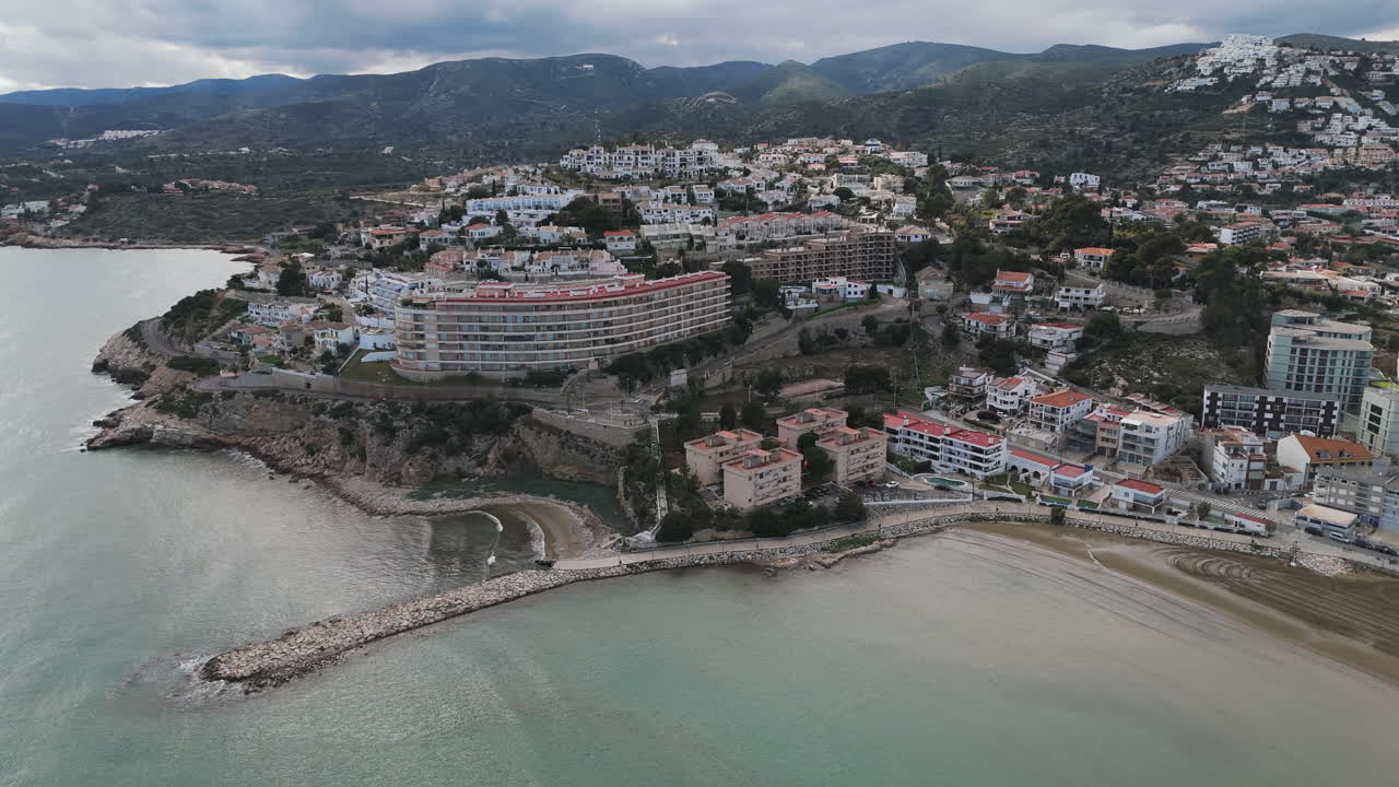 Drone captures Playa Sur beach curve, resort homes, and shoreline under daylight