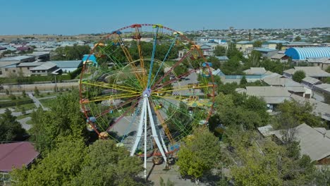 abandoned amusement park rusty ferris wheel on a sunny day in sayram near shymkent, kazakhstan