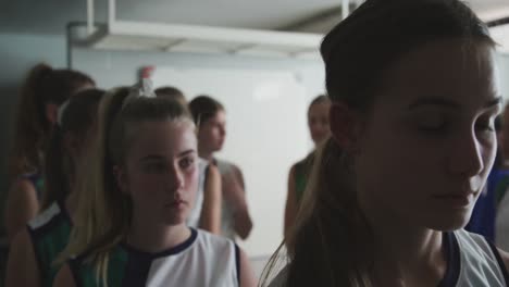 female hockey players going out of dressing room