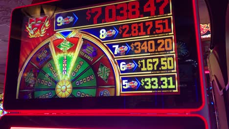 close-up of a quick hit slot machine showing jackpot amounts and a spinning wheel