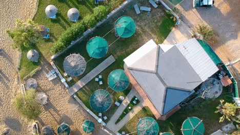 drone flying over the shacks at the tourist beach and resorts on a bright sunny day