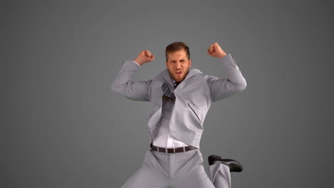 succesful businessman jumping on grey background